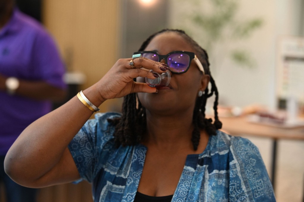 Customer sampling Prime Rise Hibiscus Bloom at a tasting